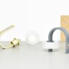 Flexible adhesive tape dispensers in pastel colors, with a kraft paper envelope in the background, showcasing minimalist desk accessories for home or office organization.