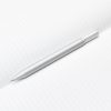 A sleek silver pen resting on an open, lined notebook page for writing or note-taking.