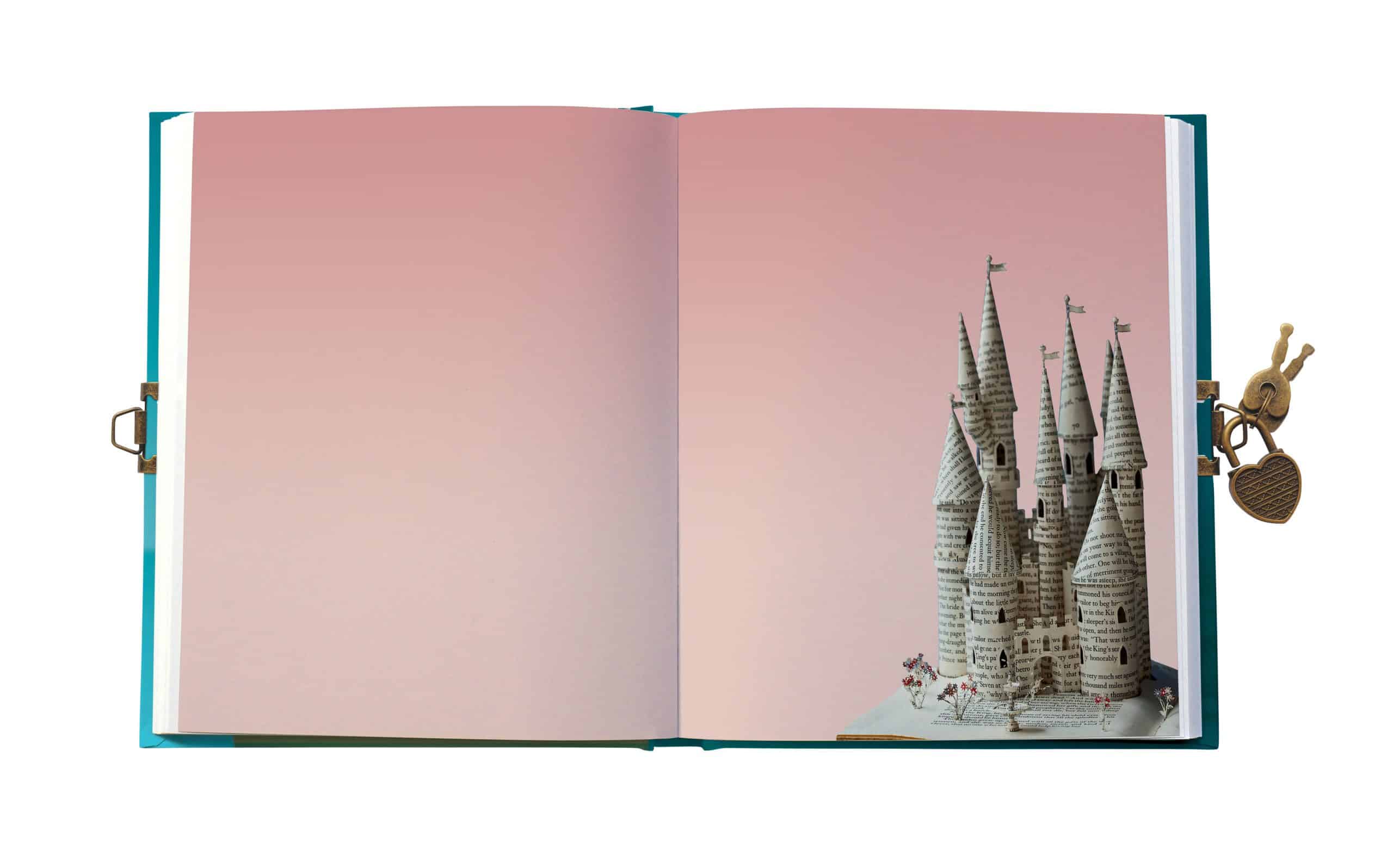 Vibrant Cinderella Castle paper sculpture inside an open book, created with recycled pages and showcasing eco-friendly art at The Wraperie, specializing in creative gift wrapping and paper art.