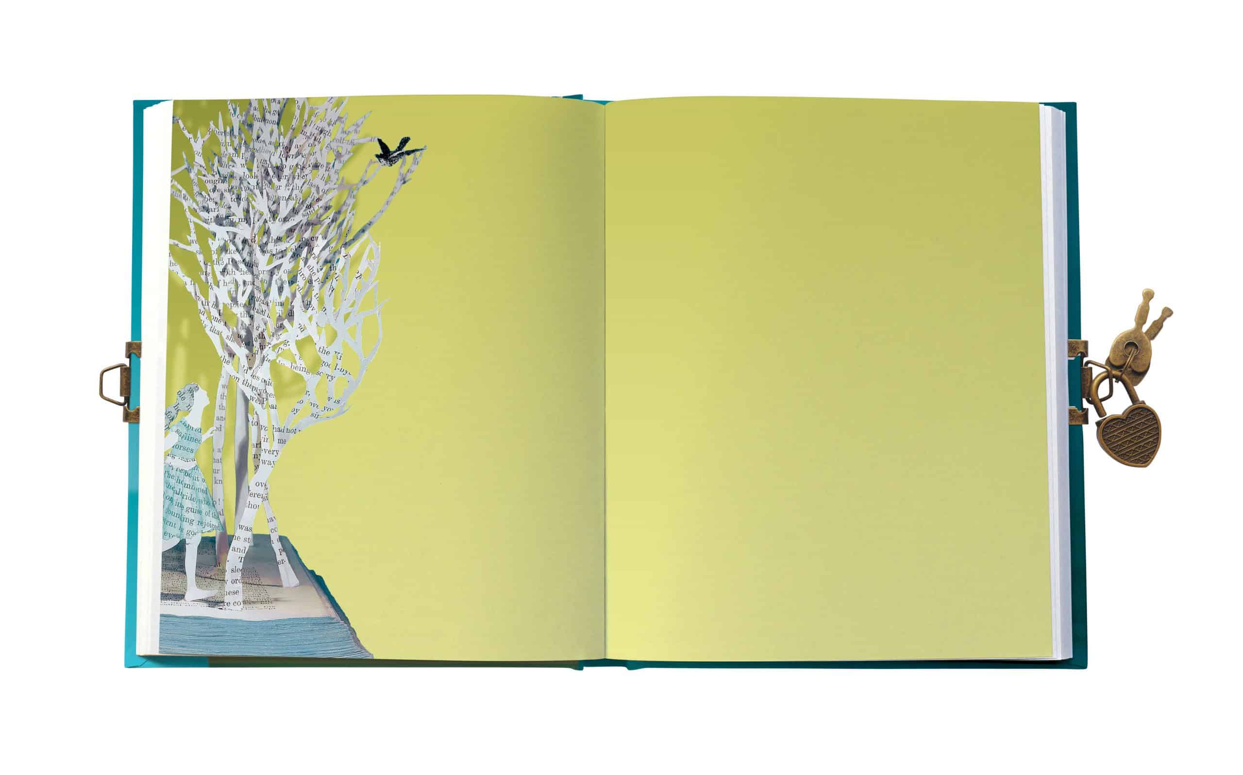 Colorful open scrapbook with paper cut-out tree design on the left page and plain yellow background on the right, featuring a small lock and key embellishment attached to the side.
