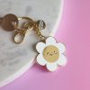 Colorful keychain with a cute smiling flower charm, gold accents, and a 
