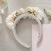 Soft white floral wedding tiara with pearl and rhinestone embellishments, perfect for bridal accessories and special occasions.