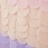 Bright pastel pink, purple, and peach paper circle decorations for party decor, event backdrop, or celebration setup, creating an elegant and festive atmosphere.