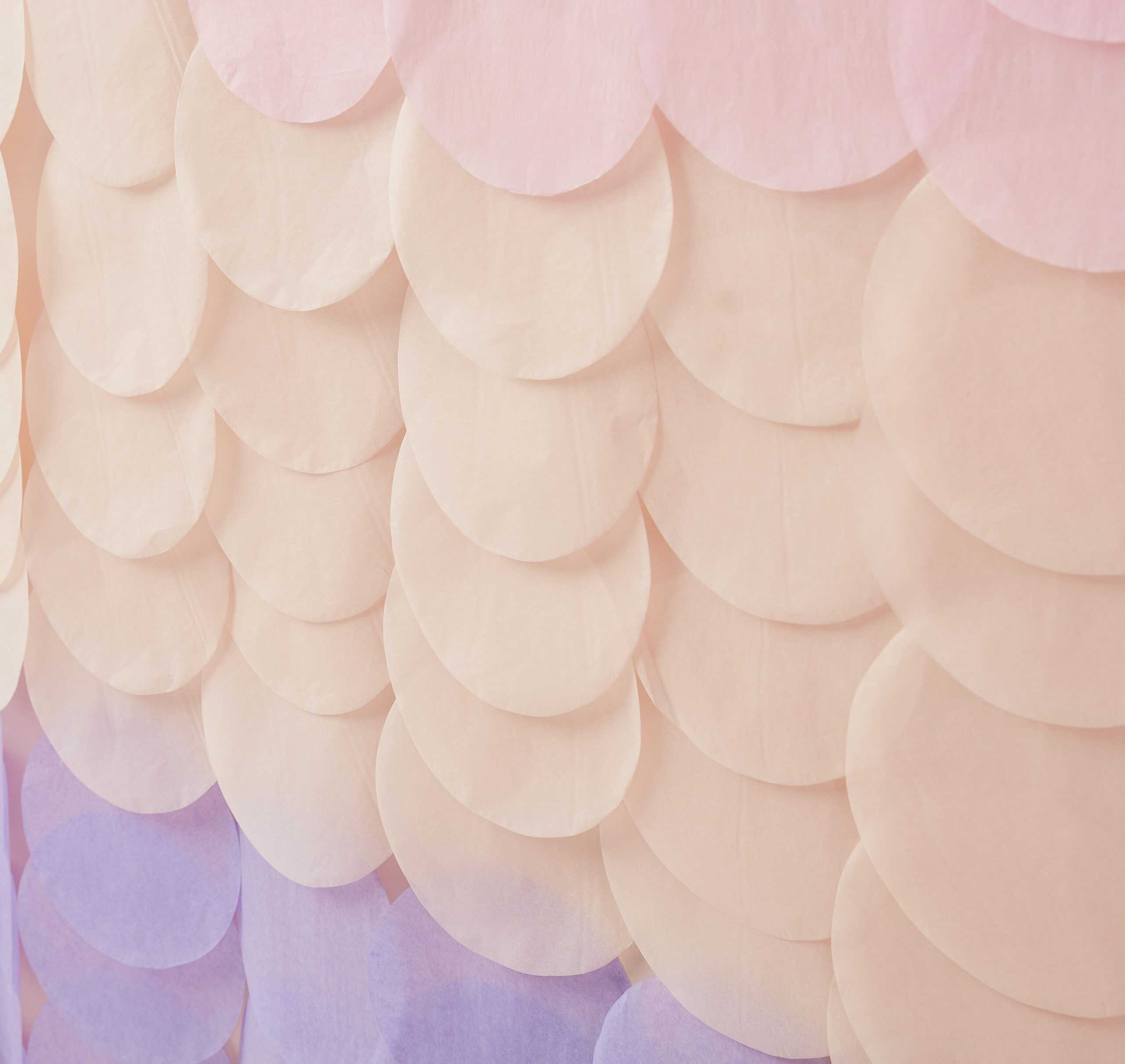 Bright pastel pink, purple, and peach paper circle decorations for party decor, event backdrop, or celebration setup, creating an elegant and festive atmosphere.