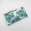 Vegan-friendly tropical leaf printed clutch bag with gold zipper and the phrase "You Have Got This" in gold lettering. Stylish accessory for everyday or special occasions.