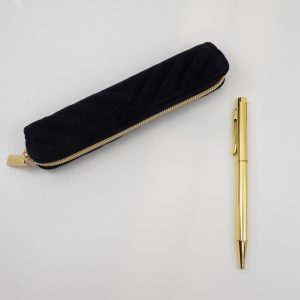 Stylish black velvet glasses case with gold zipper and decorative pattern, ideal for protecting eyewear and accessories. Perfect for organization and travel convenience.