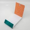Vibrant takeout container with orange polka dot interior and teal accent, perfect for fresh wraps and food packaging from The Wraperie.