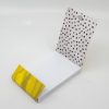 Custom printed food wrapper with dotted design and yellow accent for The Wraperie, a specialty wrap shop. Perfect for food presentation and branding.