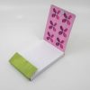 Bright pink floral patterned product hang tag with blue accents on a white background.