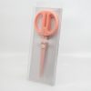 Pink silicone cake scissors in clear packaging for the Wraperie bakery.