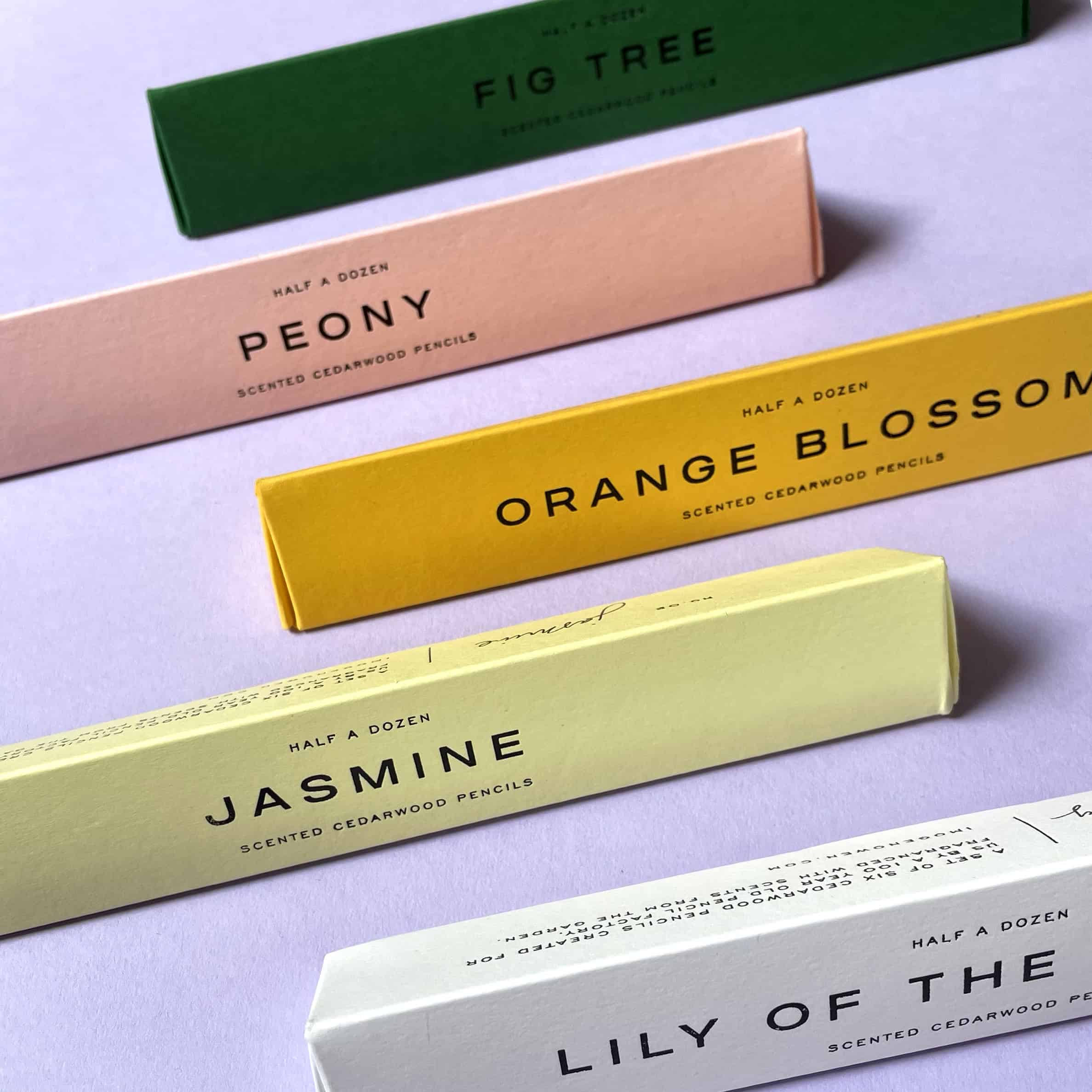 Beautifully packaged scented cedarwood pencils with pastel-colored boxes, showcasing The Wraperie’s stylish presentation of natural, fragrant stationery for home or office use.