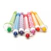 Bright colorful party blowers with patterned wraps in green, blue, purple, red, pink, orange, and yellow, ideal for celebrations and festive occasions.