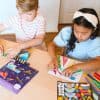 Colorful children's craft activity with paper airplane kits and markers at The Wraperie, encouraging creativity and fun for kids.