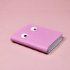 Bright pink notebook with cute googly eyes cover design, perfect for kids or playful journaling.