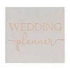 Elegant wedding planner book with a soft beige cover and rose gold lettering, perfect for organizing wedding details and timelines.