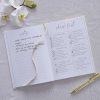 Detailed wedding planning checklist and notes on elegant white paper, with floral accents and a gold pen, perfect for organizing wedding details and timelines.