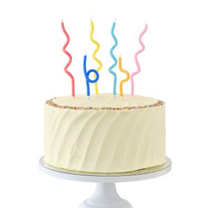 Colorful birthday cake with swirl candles and rainbow sprinkles, celebrating a special occasion. Perfect for birthdays, parties, and festive events. Bright and joyful dessert display.