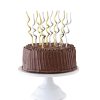 Colorful spiral candles on a rich chocolate birthday cake with chocolate shavings, perfect for celebrations and special occasions.