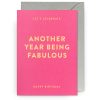 Bright pink birthday card from The Wraperie with bold yellow text saying "Another Year Being Fabulous" and "Let's Celebrate," perfect for celebrating special milestones with personalized wrapping.