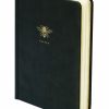 A black agenda or planner with a gold bee emblem and 