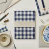 Pocket notebook with blue and cream gingham cover, ideal for journaling, sketching, or note-taking. Perfect for stationery lovers seeking stylish, high-quality paper items.