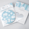 Bright blue pocket mirror with white cloud pattern, packaged in decorative box with heart-shaped cutout, perfect for gifts and accessories from The Wraperie.