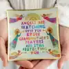 Colorful inspirational plaque with angel illustrations and a comforting message about grandmother's prayers and divine protection.