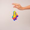 Colorful sneaker-shaped air freshener with yellow, orange, and blue accents, hanging from a hand. Perfect for adding a fun, vibrant touch to your space with stylish sneaker decor.
