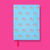 Vibrant blue planner with pink and red flower pattern, set against a pink background, perfect for organizing and style.