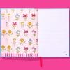 Colorful floral patterned notebook with pink, blue, yellow, red, and purple flowers on the pages, perfect for journaling or note-taking.