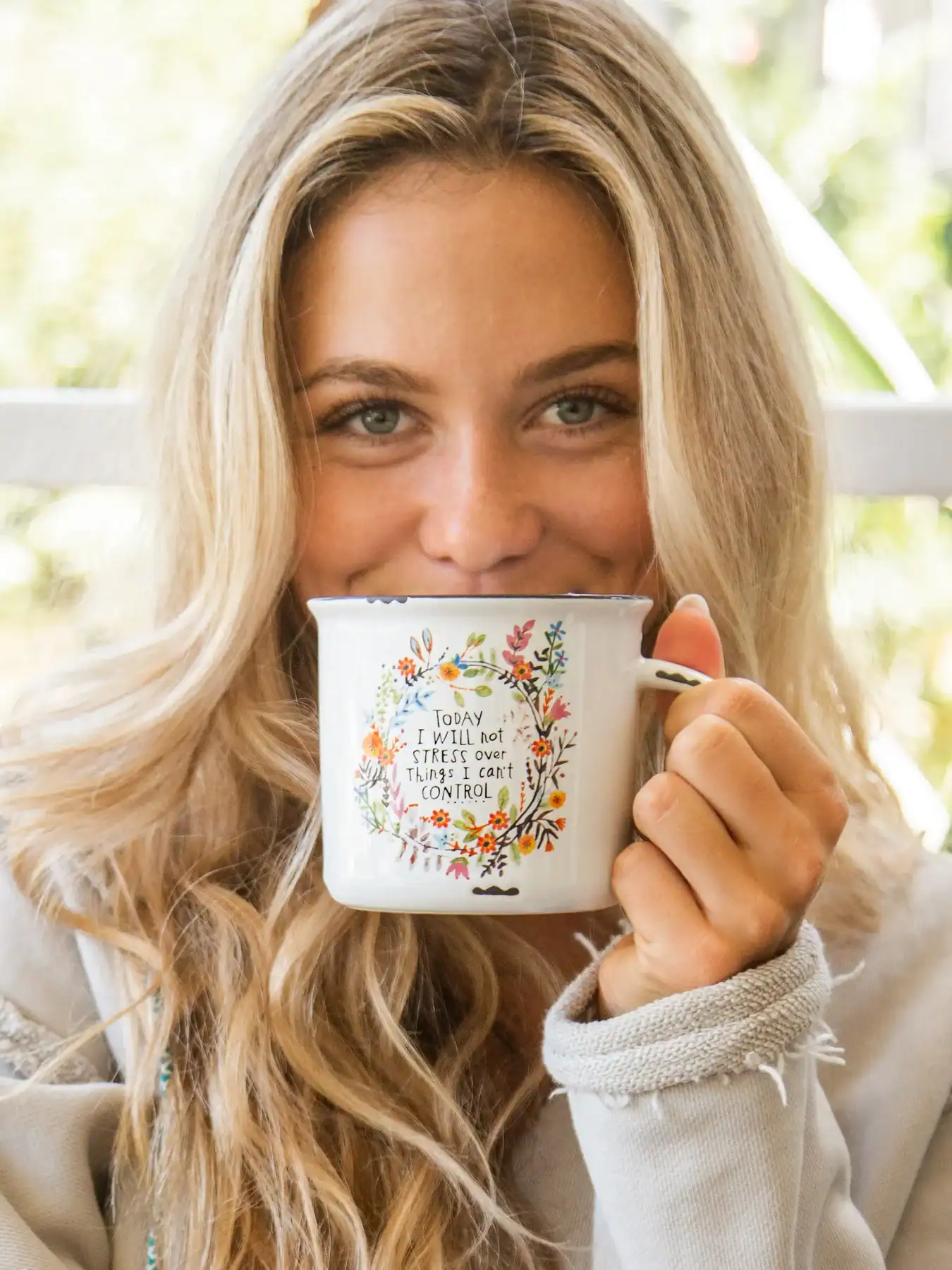 Freshly brewed coffee in a floral mug with inspirational quote, perfect for enjoying a relaxing morning at The Wraperie.