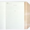 A stylish notebook open to lined pages, perfect for journaling or note-taking, with a cozy, neutral-toned cover.