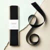 Black recycled grosgrain ribbon for craft and gift wrapping, 3 meters length. Perfect for DIY projects, embellishments, and eco-friendly packaging solutions. Sustainable and high-quality ribbon material.