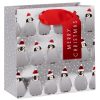 Festive Christmas penguin gift bag with red satin handle and holiday “Merry Christmas” ribbon, featuring cute penguin illustrations wearing Santa hats, ideal for holiday gift wrapping.