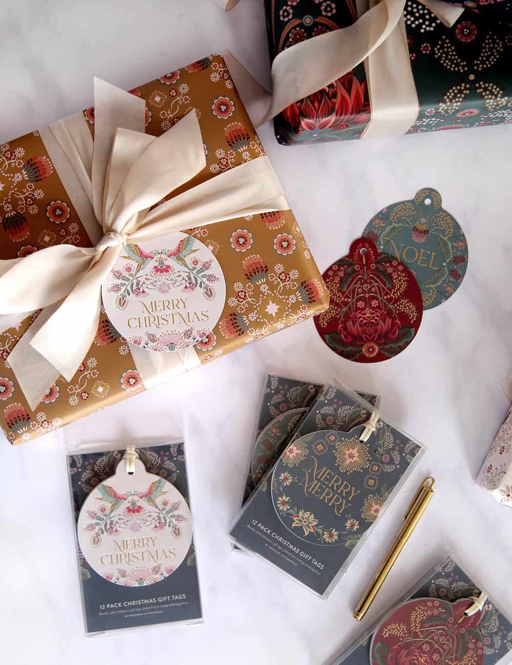 Festive holiday gift wrap with Christmas tags, wrapping paper, and ornaments featuring elegant floral and seasonal designs, ideal for Christmas gift wrapping and decoration.