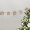 Deluxe wooden house string lights and a decorated Christmas tree with gold ornaments for holiday home decor, creating a cozy and festive holiday atmosphere.