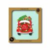 Festive Christmas wrap with holiday-themed design featuring a car, Christmas trees, and presents, perfect for eco-friendly gift wrapping at The Wraperie.