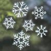 Snowflake window decals or stickers with winter-themed designs, perfect for holiday decor.