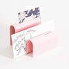 Colorful paper sample holder with various patterned and handwritten note cards, ideal for personalized stationery and gift packaging.