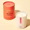 Aery Positive Energy scented candle with pink grapefruit, ylang ylang, violet, and lemon in a sleek white container.