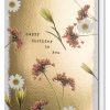 Soft floral birthday card featuring daisies and pink flowers on a gold textured background for celebration wishes.