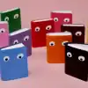 Rainbow-colored notebooks with googly eyes, perfect for fun journaling or note-taking at The Wraperie. Bright, playful, and creative stationery for kids and adults alike.