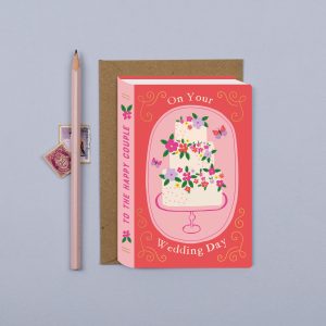 Delightful wedding greeting card from The Wraperie featuring a floral cake design and celebratory message, perfect for expressing love and congratulations on your special day.
