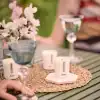 Elegant outdoor dining table with candles, flowers, and wine glasses, perfect for a cozy, stylish dinner experience at The Wraperie.