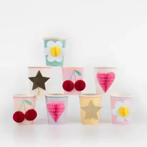 Colorful paper cupcake wrappers decorated with flowers, hearts, stars, and cherries, perfect for themed parties or festive celebrations, showcasing creative party decor ideas from The Wraperie.