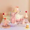 Colorful birthday cakes and dessert table with pastel decorations and party hats at The Wraperie celebration.