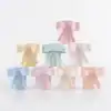 Pastel-colored decorative bow jars for gift wrapping and party favors at The Wraperie. Perfect for special occasions, adding elegance and charm to your celebration supplies.