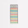 Blue, red, green, yellow, and white striped birthday candles in a rectangular box, perfect for celebrating special occasions.