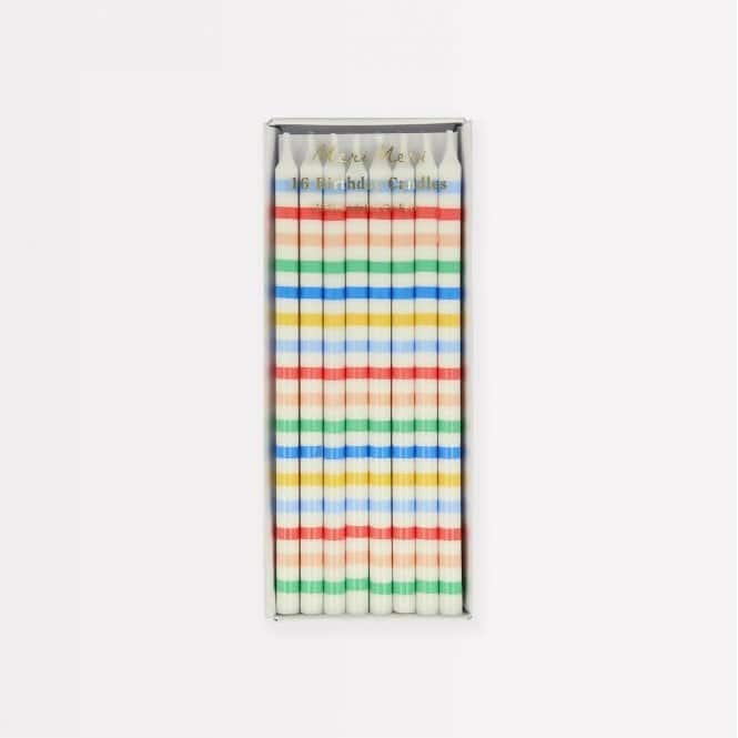 Blue, red, green, yellow, and white striped birthday candles in a rectangular box, perfect for celebrating special occasions.