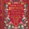 Vibrant red birthday card designed to resemble a classic book cover, featuring floral and butterfly motifs, with gold accents and celebratory message, perfect for book lovers.